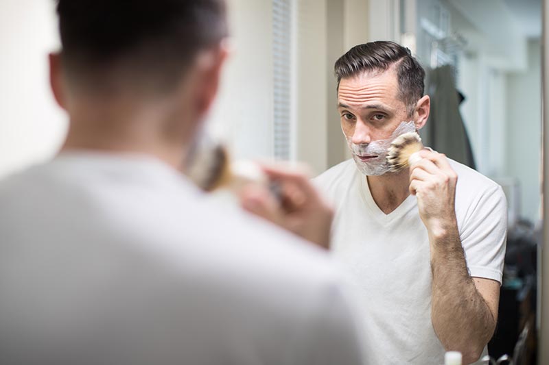 shaving routing using badger hair shave brush in mirror with amazing lather